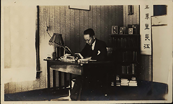 Kung in his room studying at desk