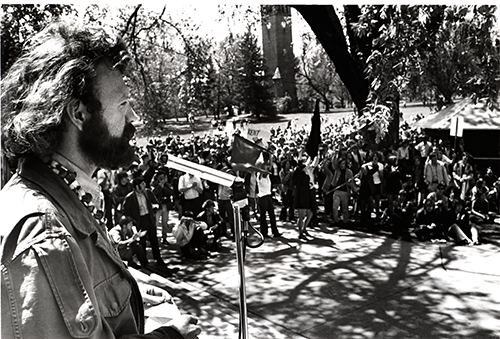 Image of a student rally on campus with the campanile visible in the background