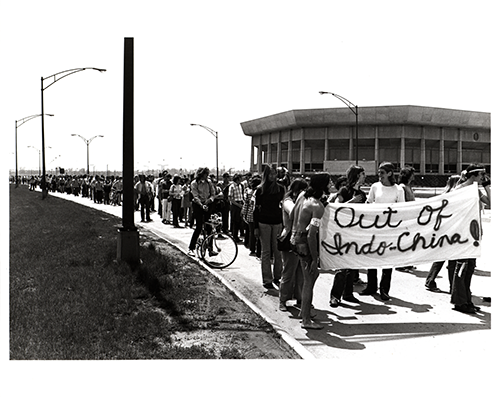 Image of student protesters marching outside the coliseum