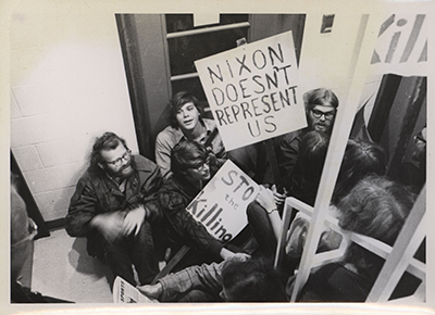 Image of students sitting in a local selection services office with signs
