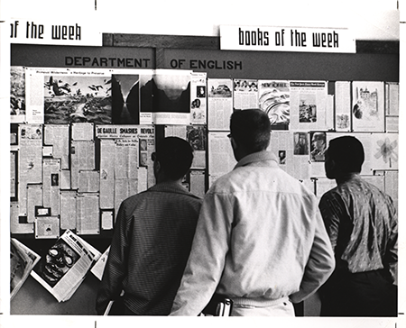 Image of students looking at the English Department bulletin board