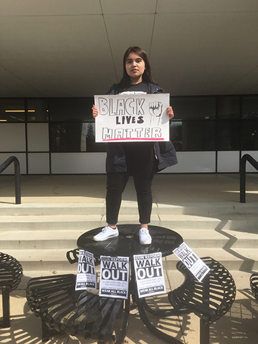 image of Julissa Garcia protesting with poster "Black Lives Matter"